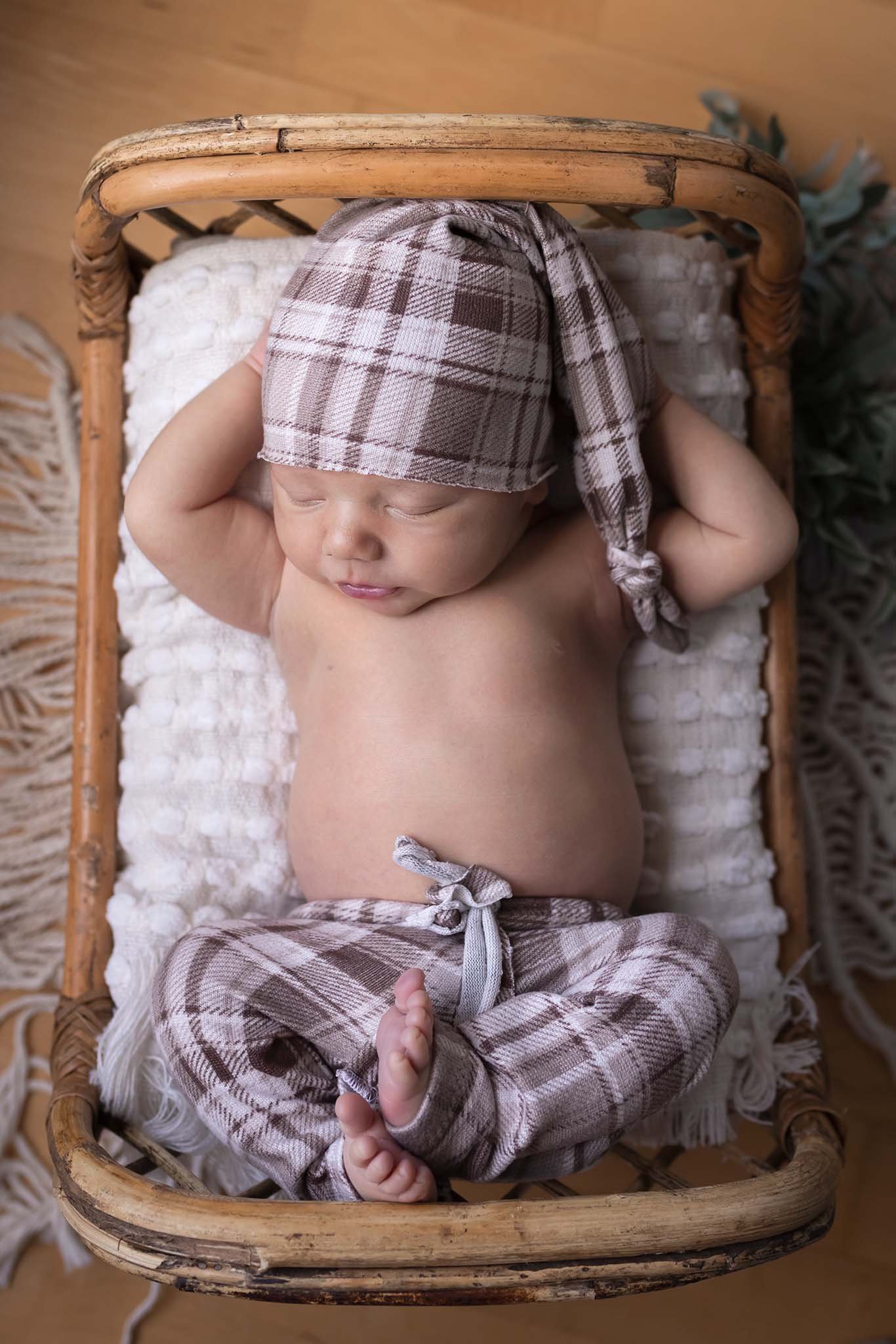 newborn with his hands behind his head
