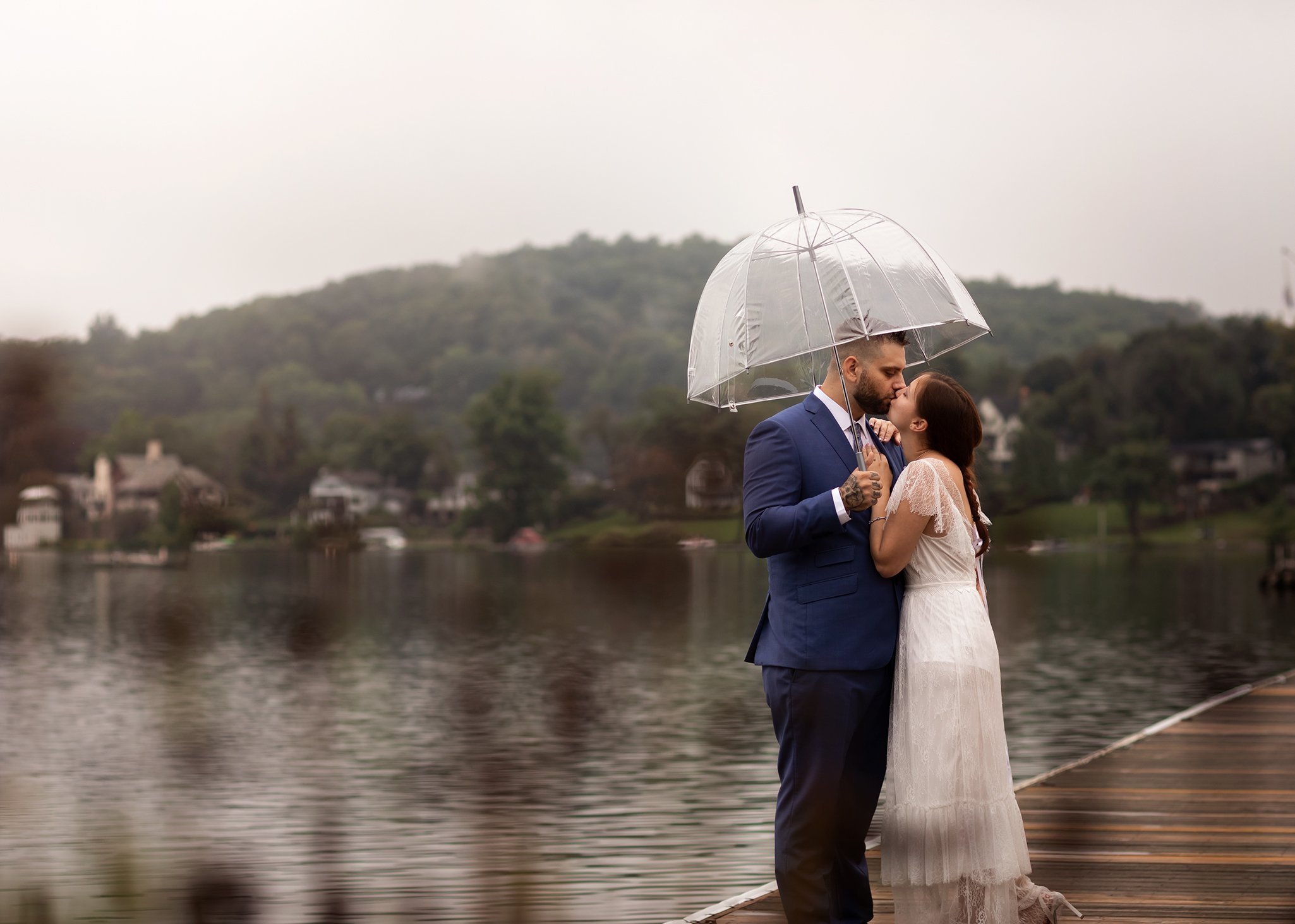 wedding couple kissing under umbrella