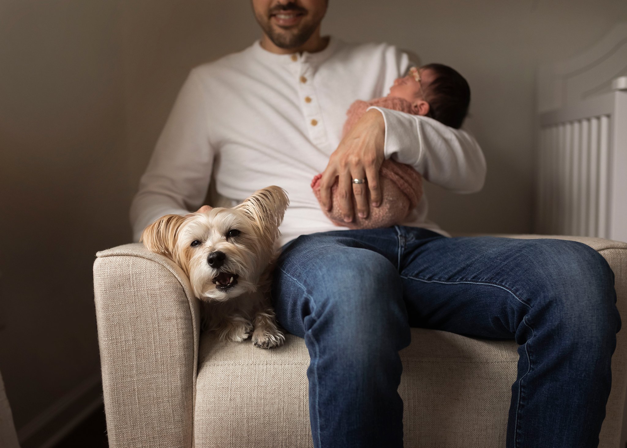 dad holding dog and baby