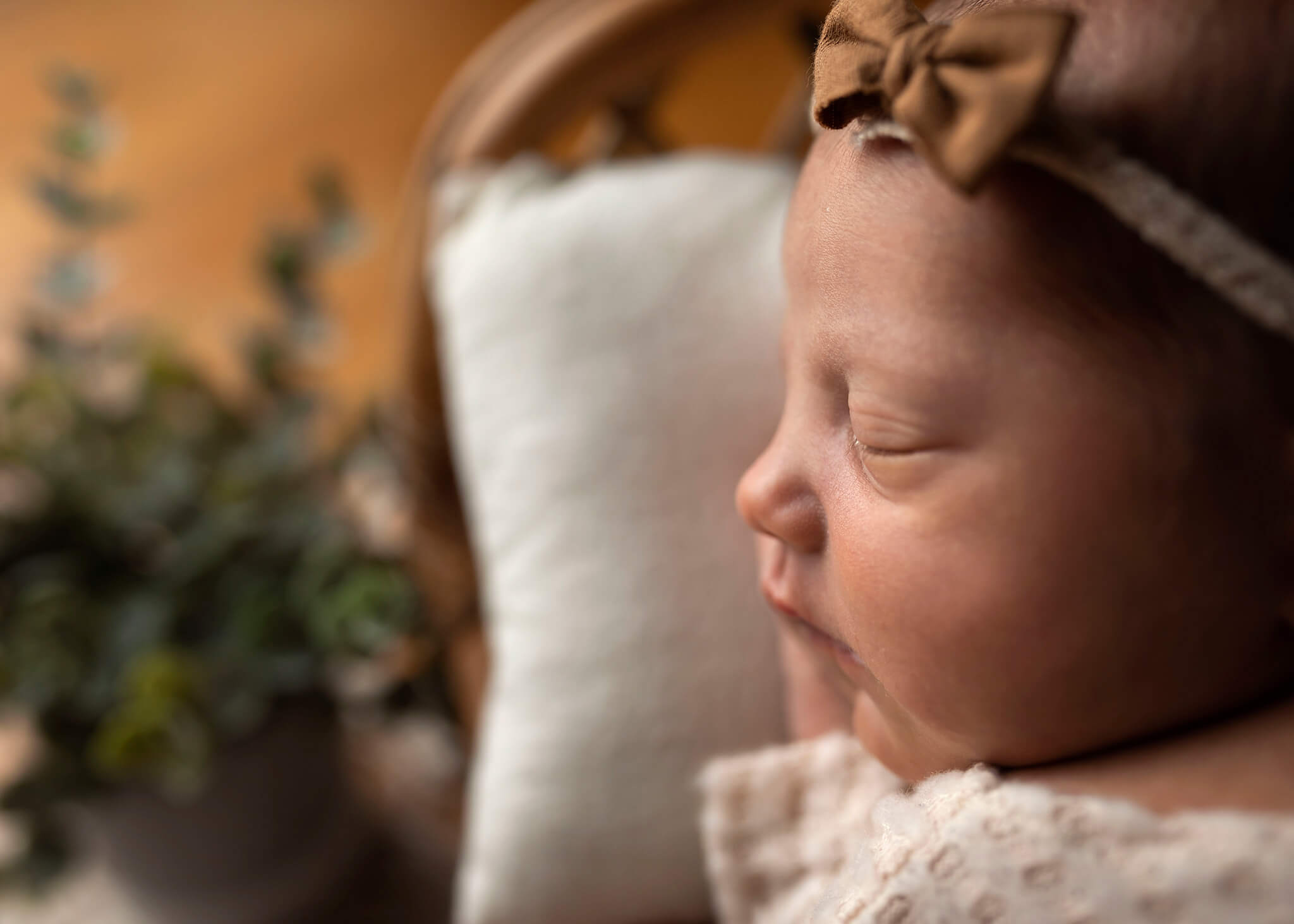 Profile of a newborn baby laying on a pillow. Midwives of New Jersey