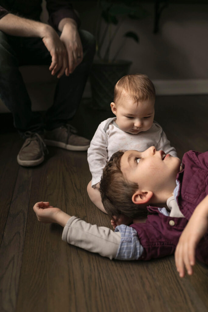 Big brother looks up at his big sister during their NJ lifestyle photography session