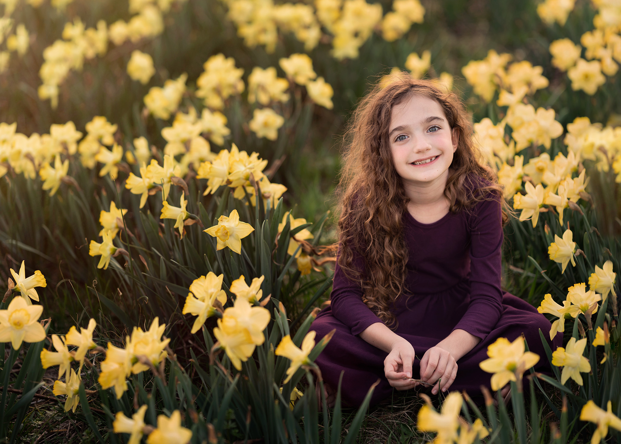 Girl sits in a field of daffodil flowers I Things to Do in Madison NJ with Kids