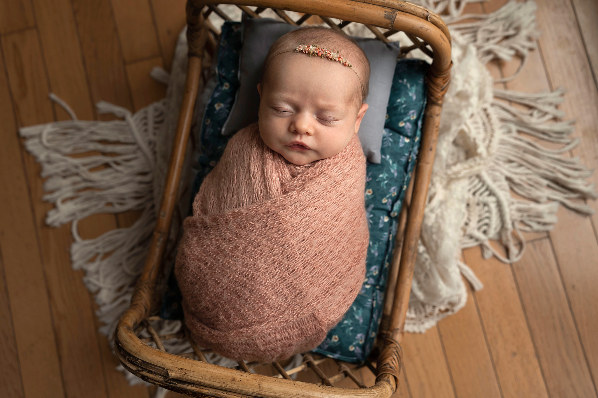Wrapped baby in little bamboo bed